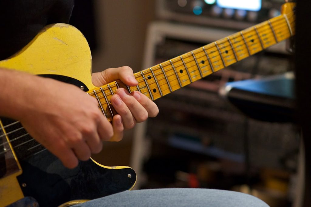 person-playing-yellow-and-black-acoustic-guitar-zyp1jexkzaw person-playing-yellow-and-black-acoustic-guitar-zyp1jexkzaw